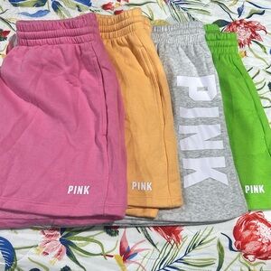 4 pair of Victoria Secret pink shorts. 1 grey..1 pink..1 green..1 orange.